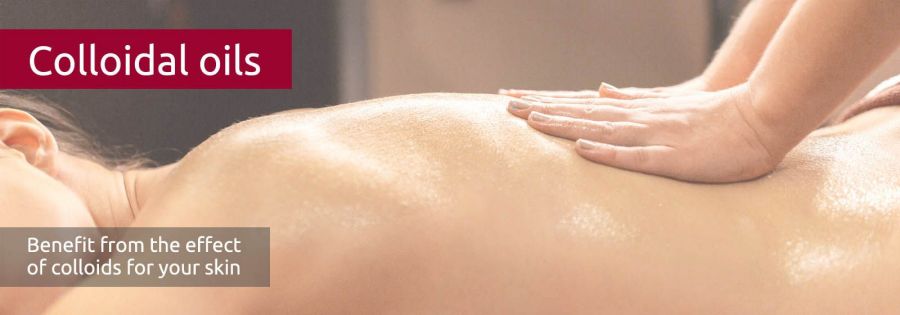 A woman's back is gently massaged and shines with oil